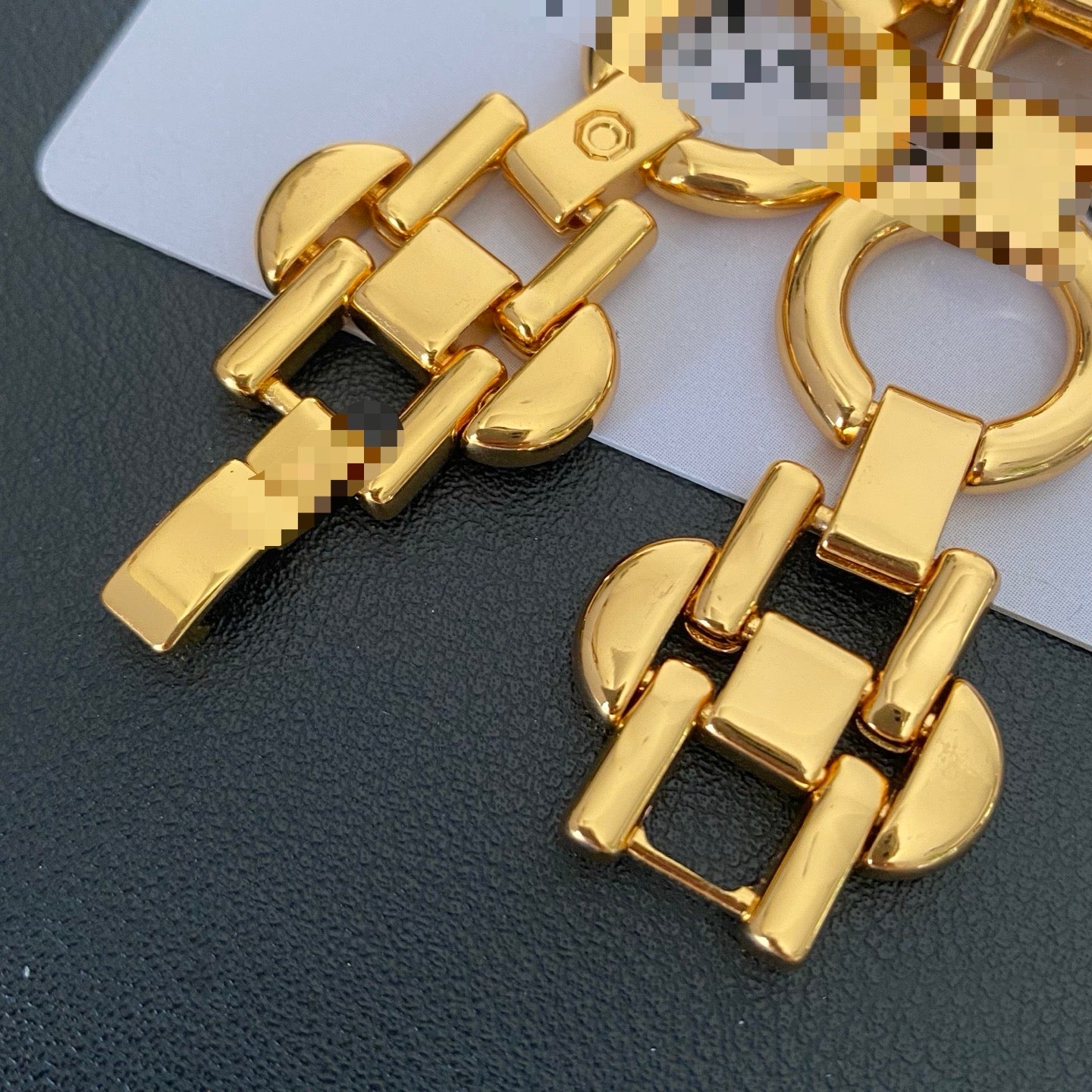 Close view of polished geometric links on the gold-tone bracelet