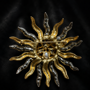 Back view of a two-tone sunburst statement brooch showing the pin fastening