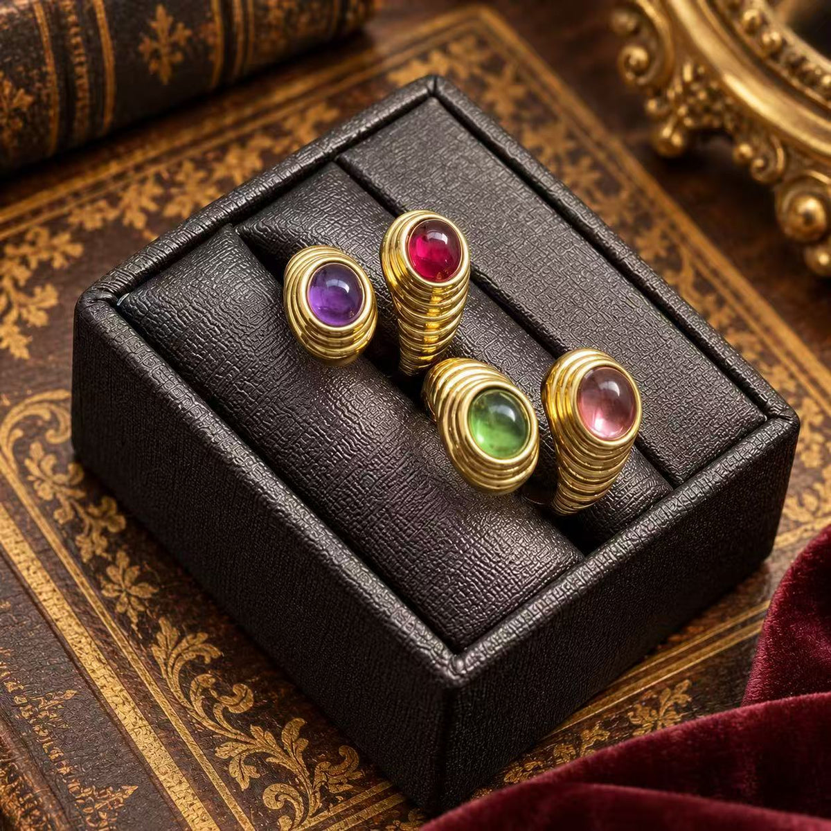 Gold-tone open band rings with purple, red, green and pink oval glass details