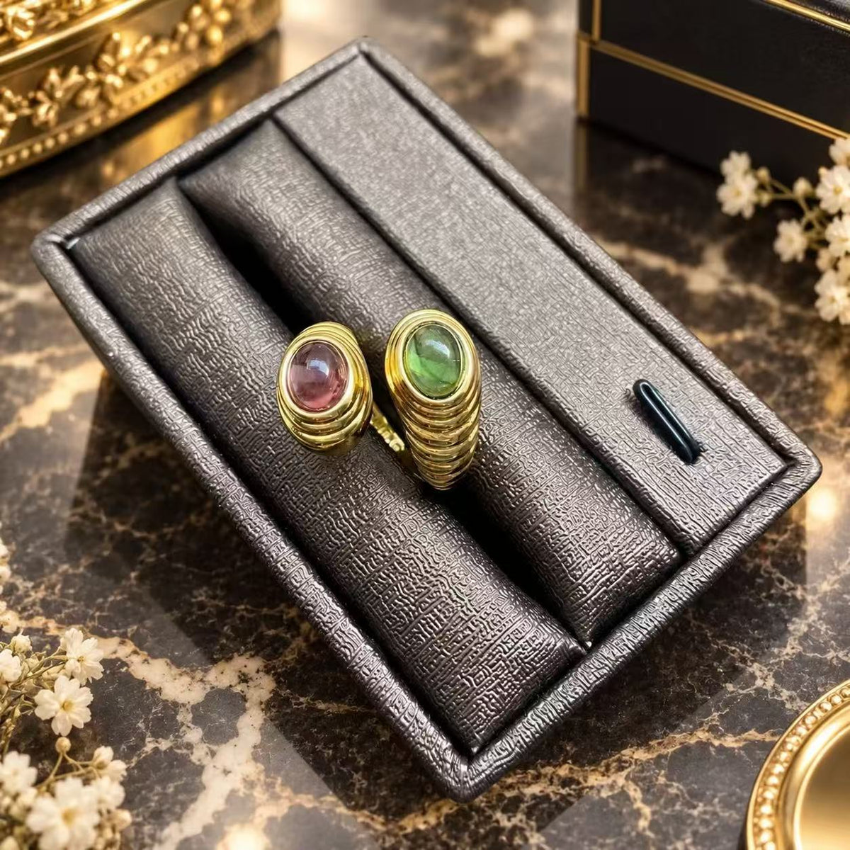 Pink and green glass open band rings with gold-tone ridged bands