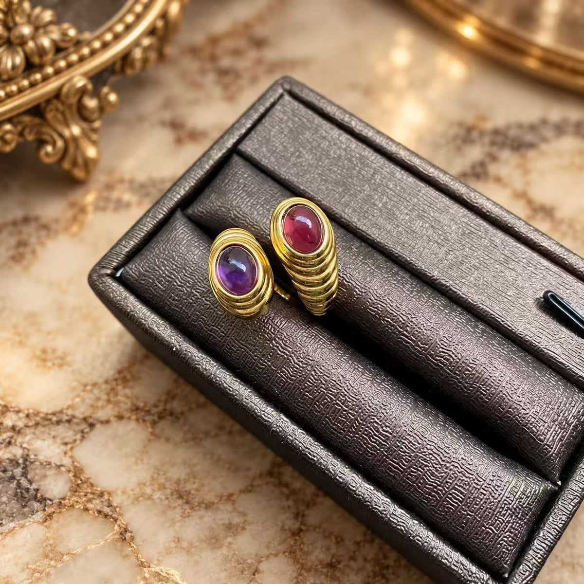 Purple and red glass open band rings with gold-tone ridged bands