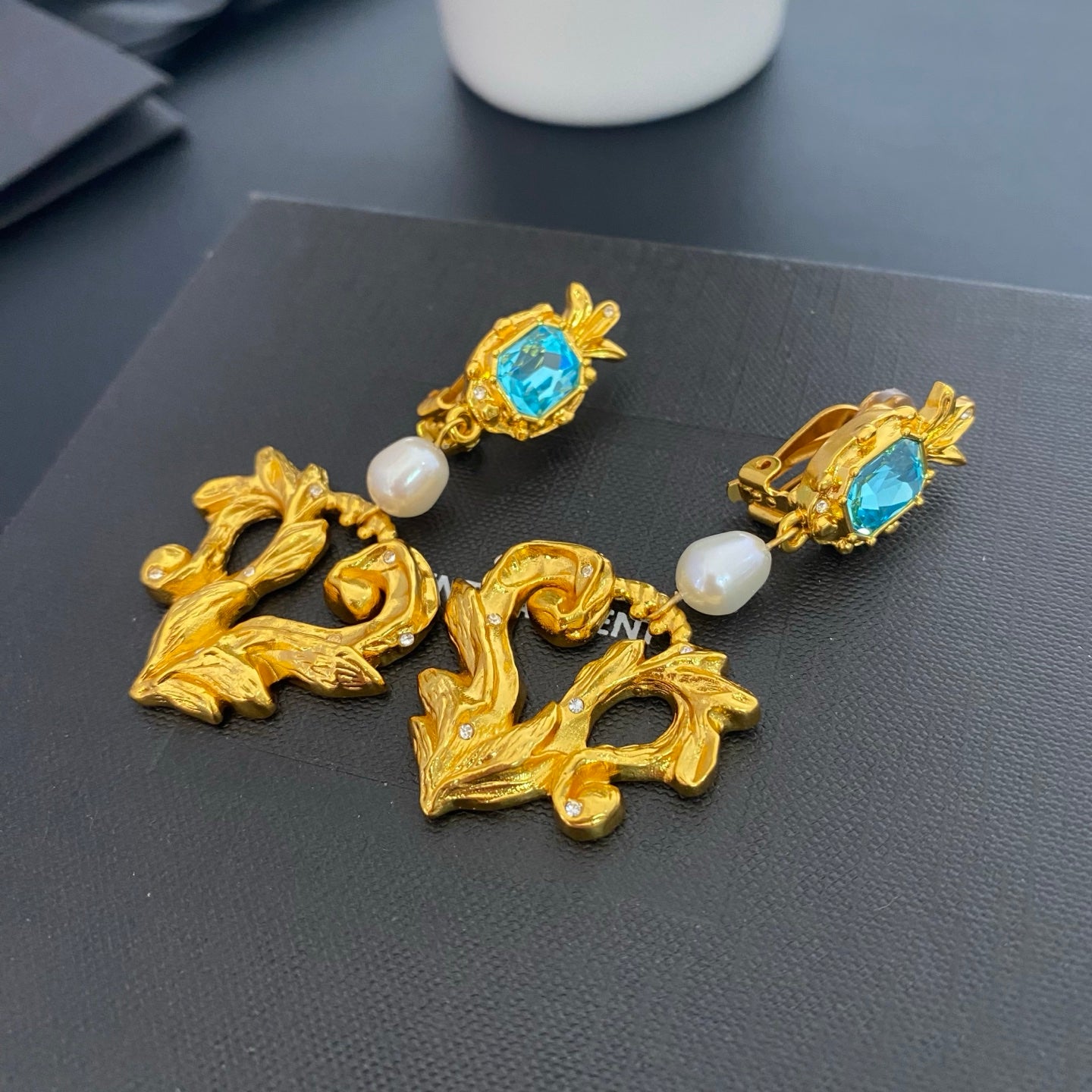 Angled view of natural pearl lava heart clip-on earrings showing the clip fastenings