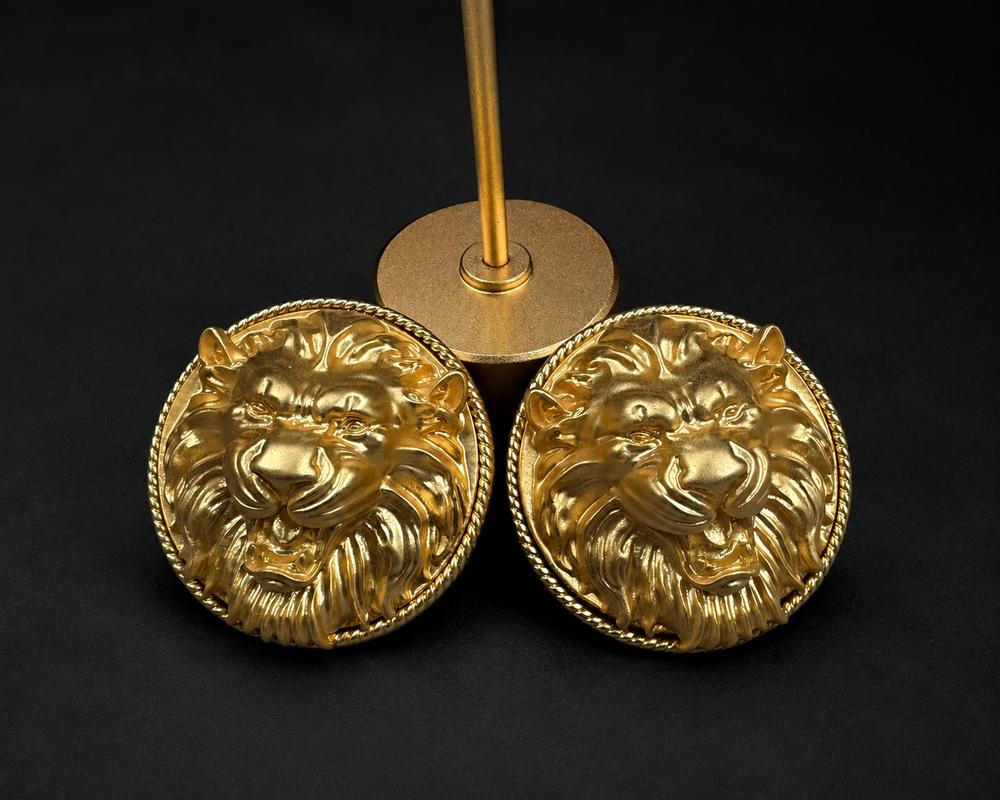 Pair of gold-tone lion head clip-on earrings with round twisted-rope borders