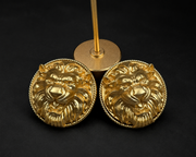 Pair of gold-tone lion head clip-on earrings with round twisted-rope borders