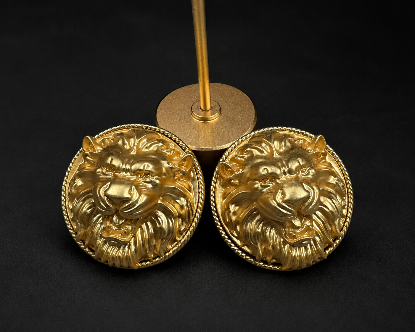 Pair of gold-tone lion head clip-on earrings with round twisted-rope borders