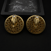 Back view of gold-tone lion head clip-on earrings with white comfort pads