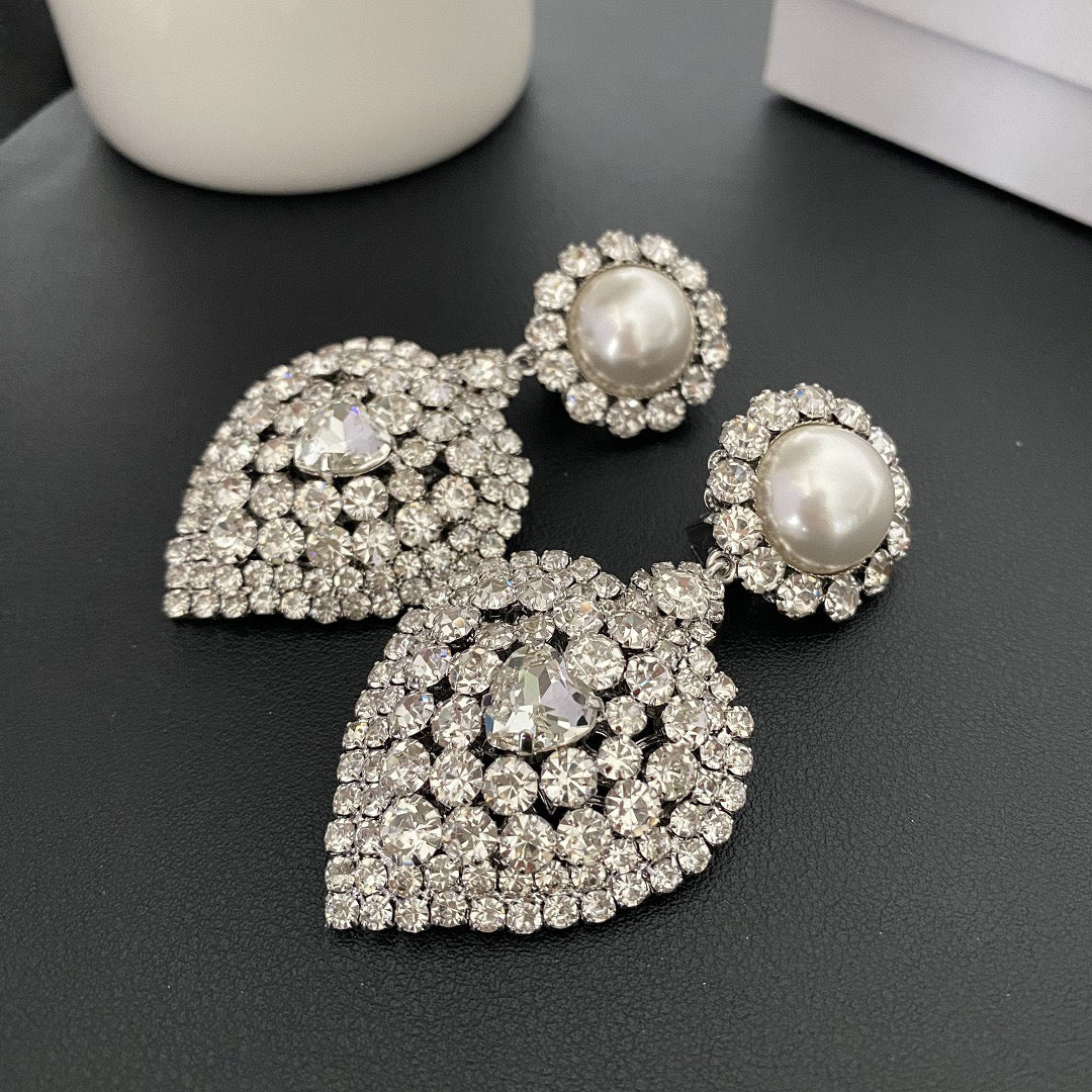 Pair of silver-tone clip-on earrings with pearl-style tops and crystal heart drops