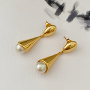 Front view of 18K gold-plated pearl-style drop stud earrings with sculptural cone pendants