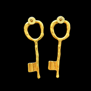 Back view of gold-tone key-shaped stud earrings showing post backs
