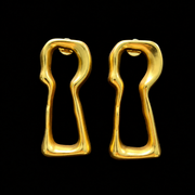 Front view of gold-tone lock-shaped stud earrings on a black background