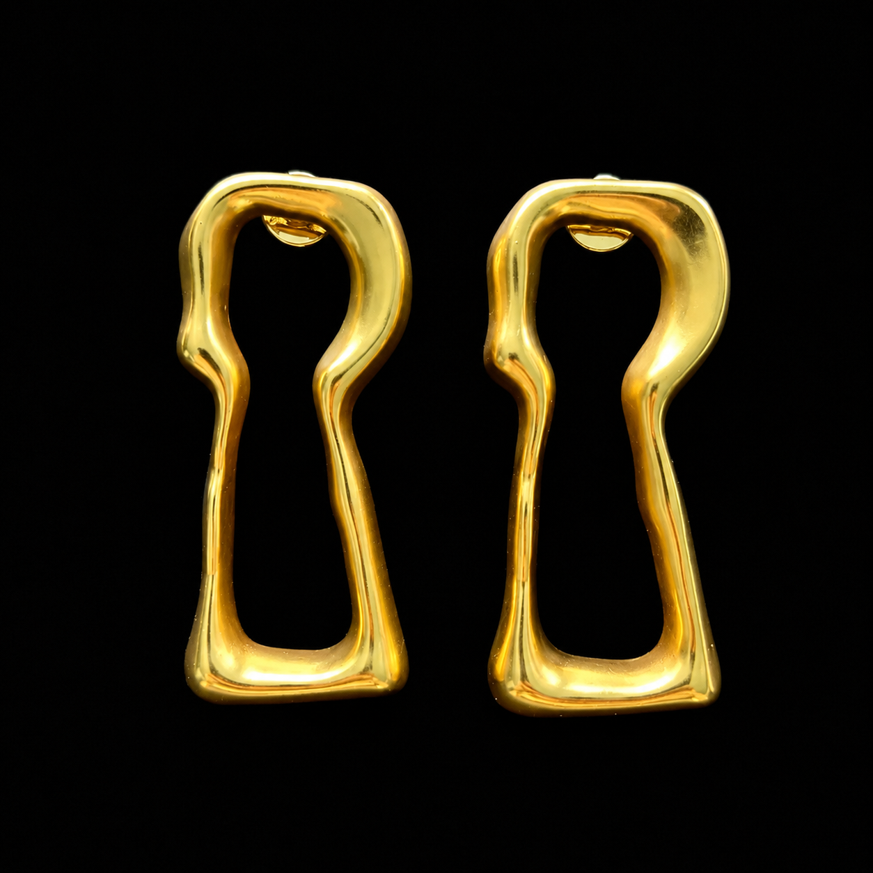 Front view of gold-tone lock-shaped stud earrings on a black background