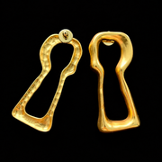 Back view of gold-tone lock-shaped stud earrings showing post backs