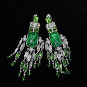 Green geometric clip-on earrings with rectangular accents and dangling details