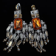 Amber-tone geometric clip-on earrings with rectangular accents and dangling details