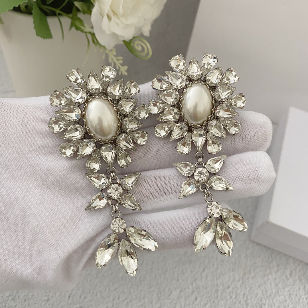 Pair of silver-tone floral pearl-style clip-on earrings with clear faceted stone tassels