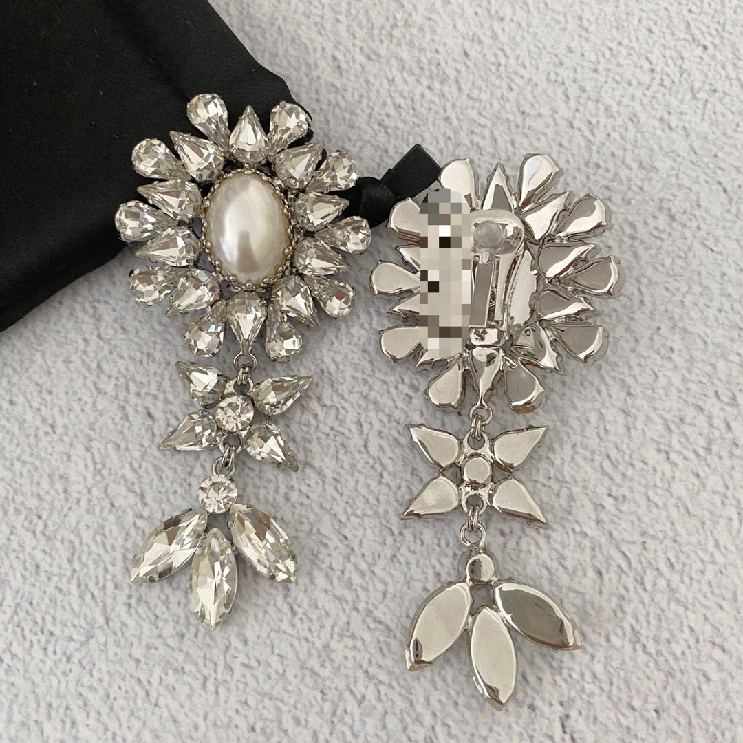 Front and reverse view showing the floral earring design and clip-on fastening