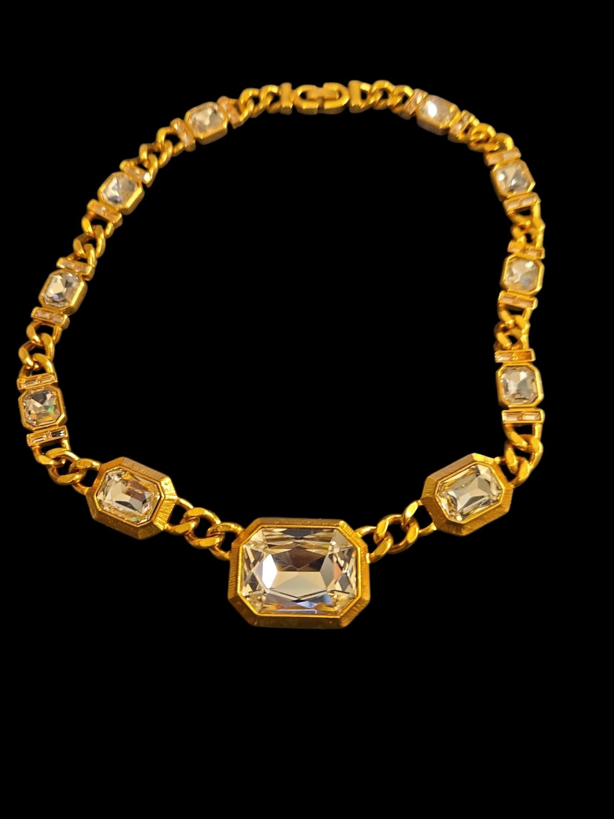 Gold-tone link necklace with graduated clear faceted rectangular accents and a large geometric centrepiece