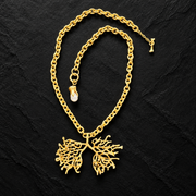 Full view of lucky tree necklace with textured gold-tone chain, branching pendant and pearl-style charm