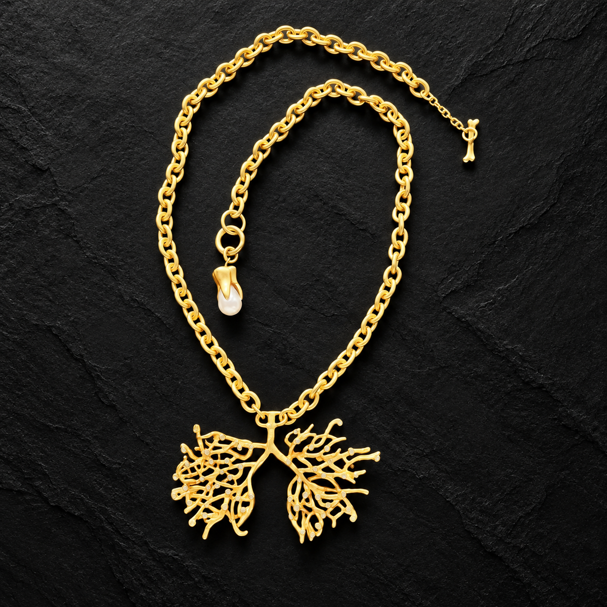 Full view of lucky tree necklace with textured gold-tone chain, branching pendant and pearl-style charm