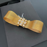Front view of the gold-tone mesh choker with clear square faceted stones
