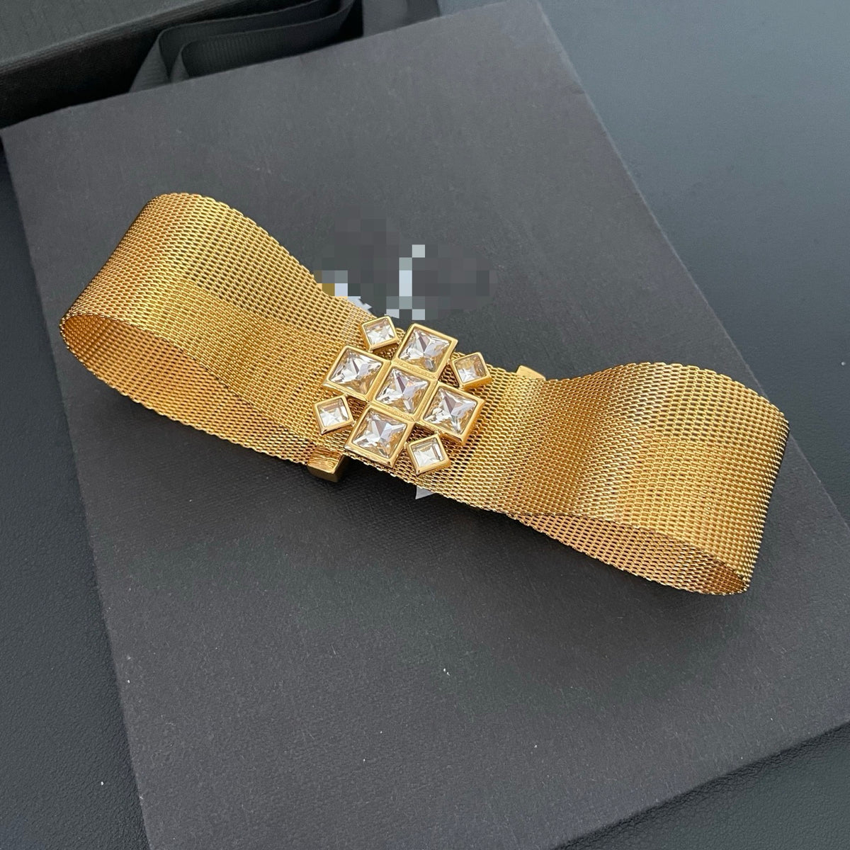 Front view of the gold-tone mesh choker with clear square faceted stones