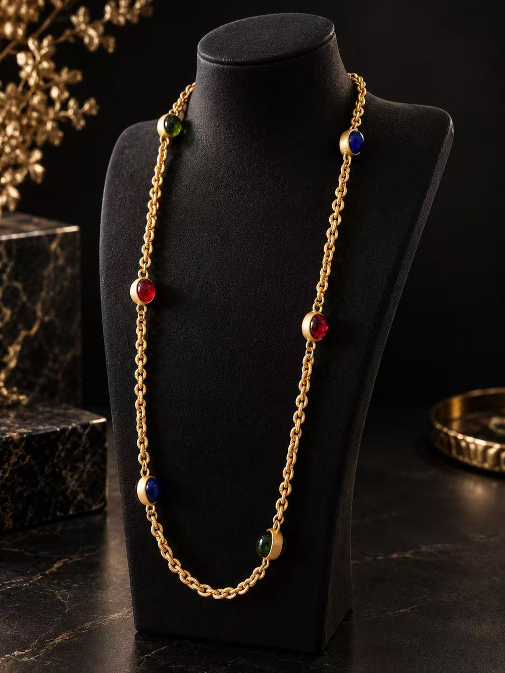 Gold-tone multicolor glass station necklace displayed on a black necklace bust