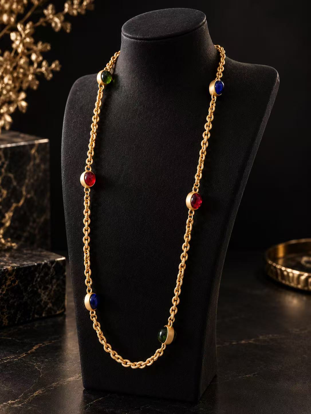 Gold-tone multicolor glass station necklace displayed on a black necklace bust
