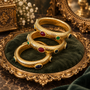 Multicolor glass ribbed stretch bangles displayed together on a tray; sold individually