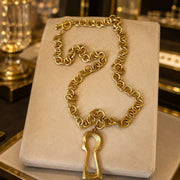 Full view of the gold-tone chunky chain necklace with removable keyhole pendant