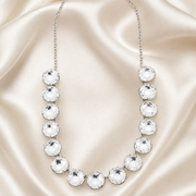 Silver-tone statement necklace with oversized clear faceted crystal-style accents