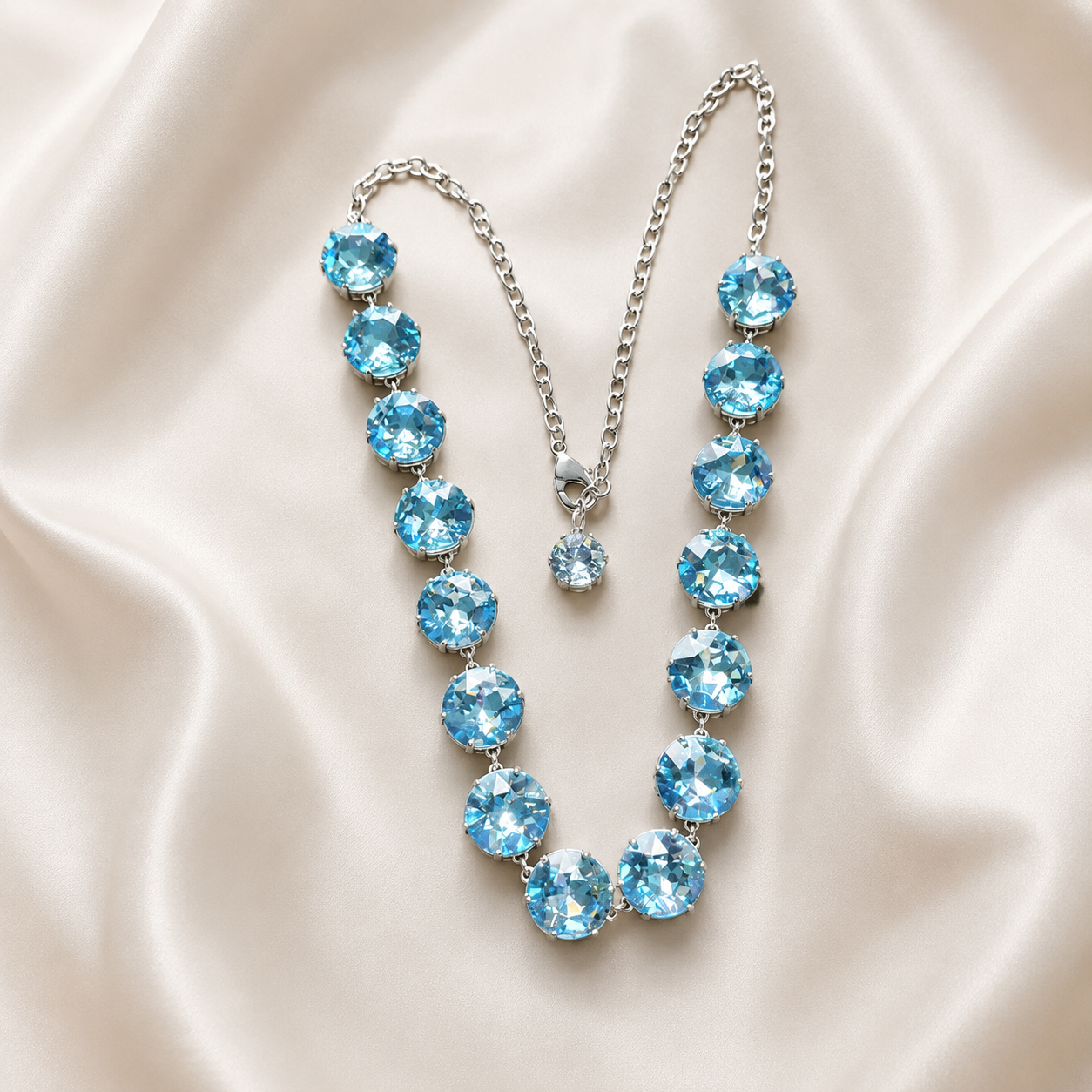 Silver-tone statement necklace with oversized blue faceted crystal-style accents