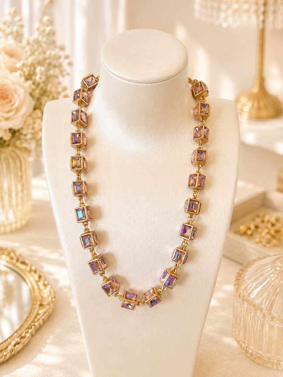 Pink-purple AB cube statement necklace on a cream display bust