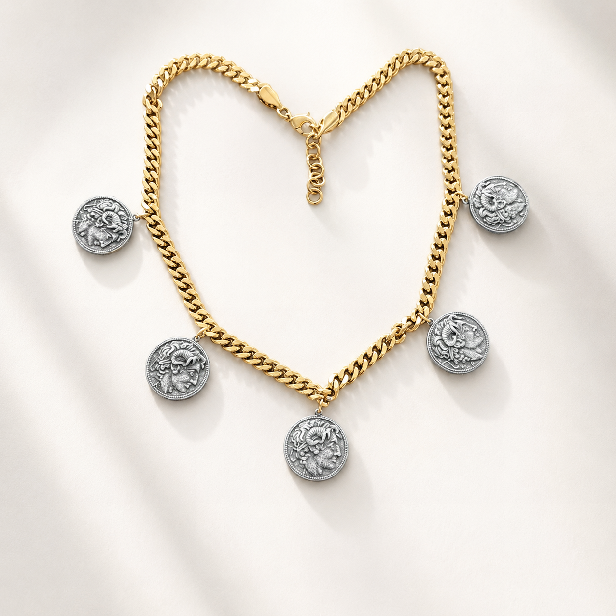 Two-tone Alexander-inspired ancient coin charm necklace showing classical profile reliefs