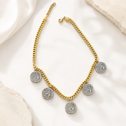 Reverse view of two-tone ancient coin-style charms on a gold-tone curb chain necklace