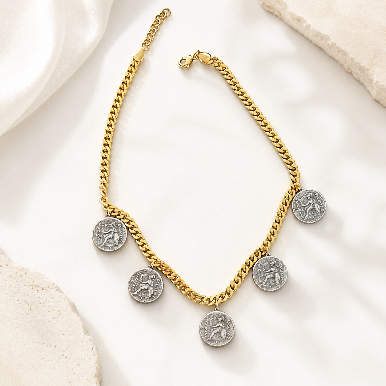 Reverse view of two-tone ancient coin-style charms on a gold-tone curb chain necklace