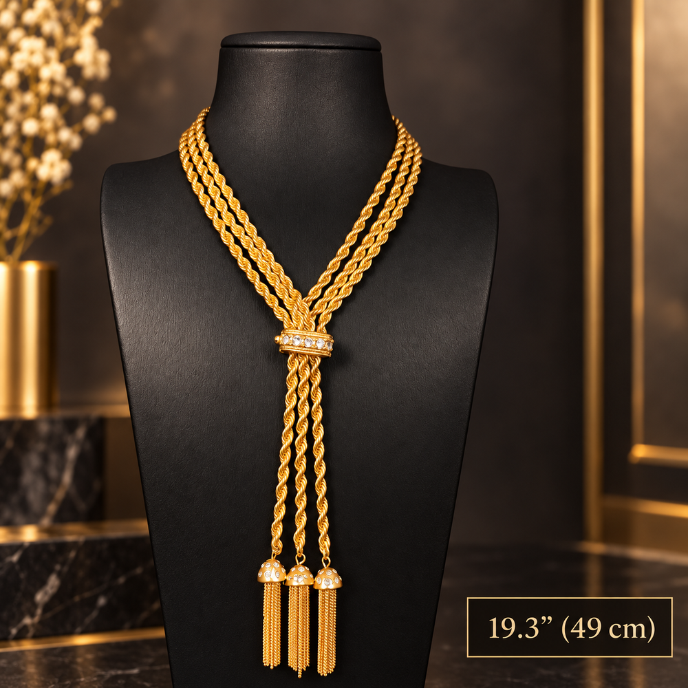 Gold-tone triple rope chain necklace with clear sparkling accents and three chain tassels displayed on a black bust, with a 49 cm length label