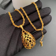 Close-up of the openwork scroll pendant and twisted rope-style necklace chain