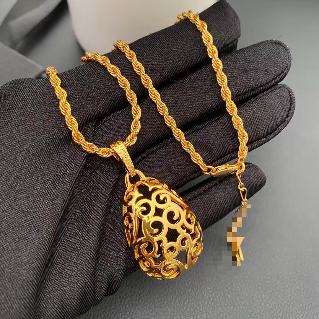 Close-up of the openwork scroll pendant and twisted rope-style necklace chain