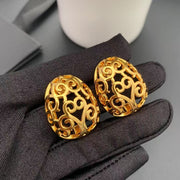 Close-up of the matching oval openwork clip-on earrings with scroll motifs