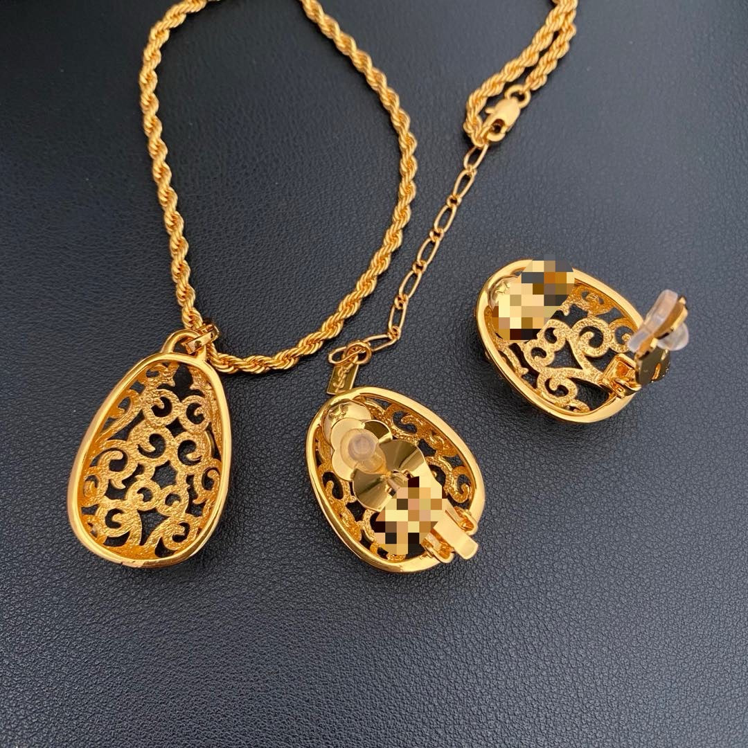 Back view of the pendant and clip-on earrings showing the closures and necklace extension chain