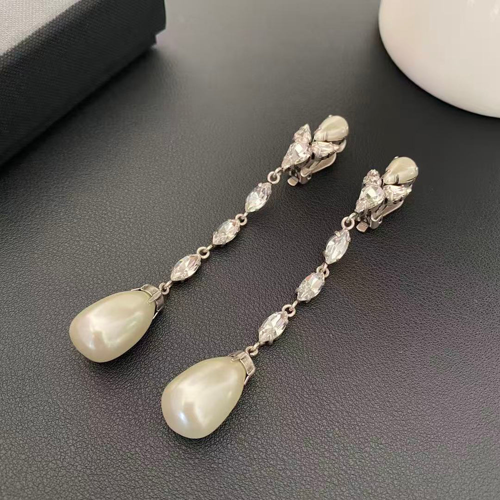 Silver-tone clip-on earrings with clear marquise-shaped stones and pearl-style teardrop pendants