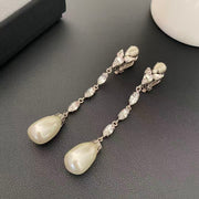 Silver-tone clip-on earrings with clear marquise-shaped stones and pearl-style teardrop pendants