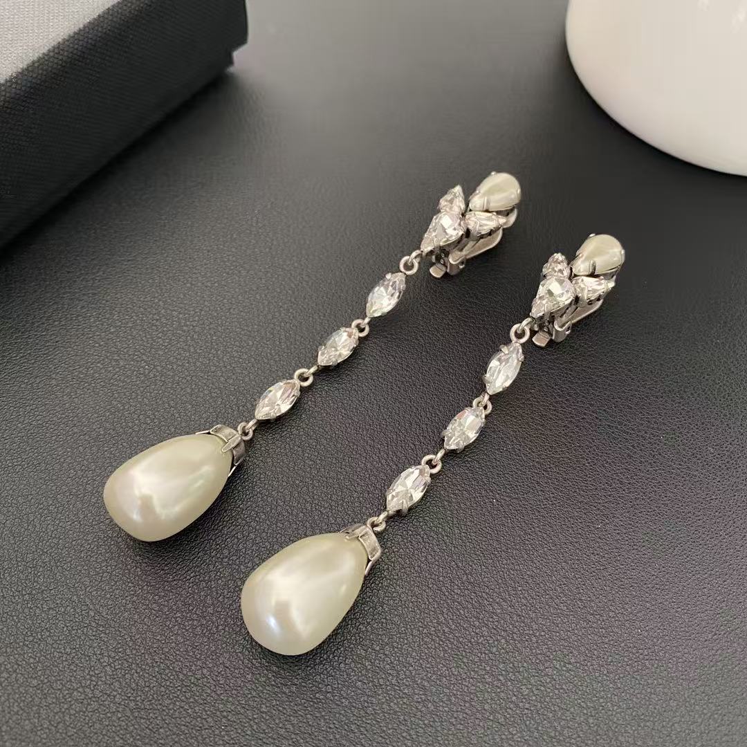 Silver-tone clip-on earrings with clear marquise-shaped stones and pearl-style teardrop pendants