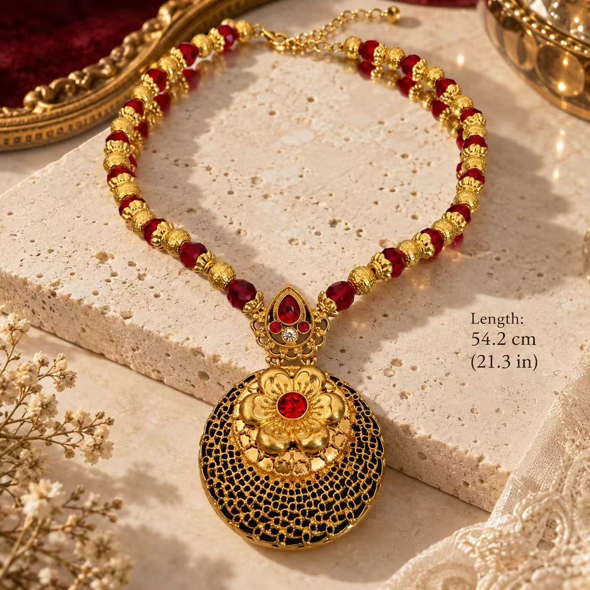 Gold-tone red beaded necklace with a floral openwork medallion pendant, showing the 54.2 cm length