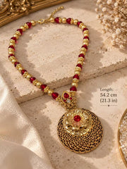 Angled view of the red beaded floral medallion necklace with its lobster clasp and extender chain