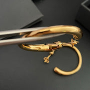 Close view of the post-back closure on a gold-plated brass hoop earring