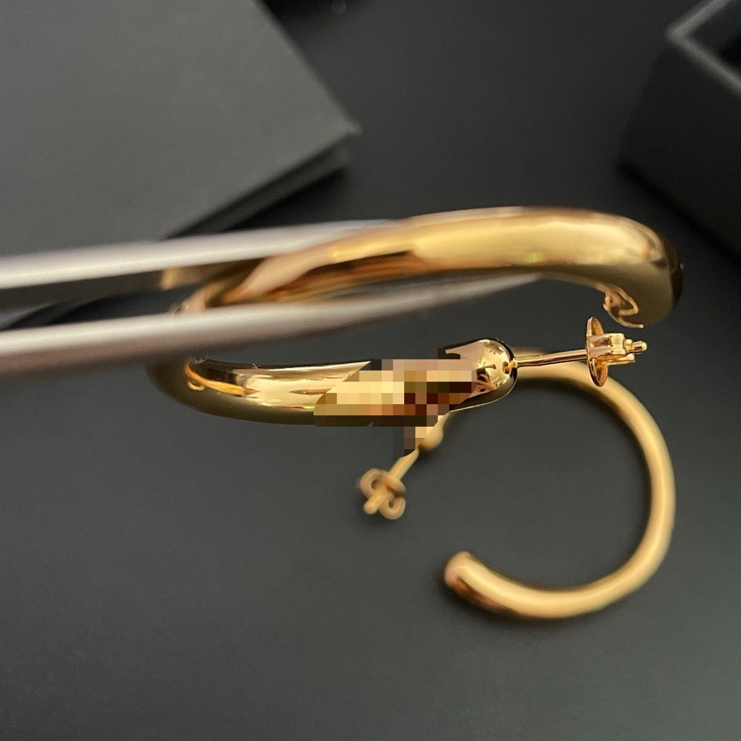 Close view of the post-back closure on a gold-plated brass hoop earring