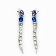 Silver-tone long linear stud earrings with blue and clear faceted crystal-style accents