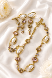 Baroque-inspired light pink rhinestone-style jewelry set on cream satin