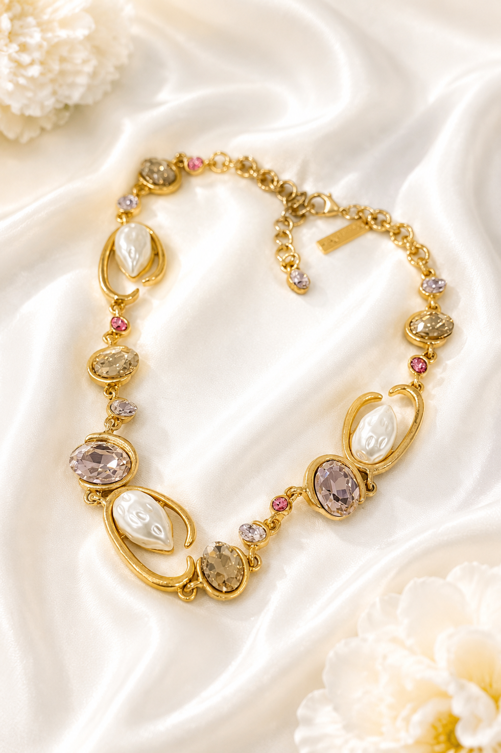 Baroque-inspired light pink rhinestone-style necklace on cream satin